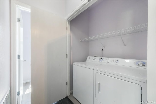 clothes washing area featuring independent washer and dryer