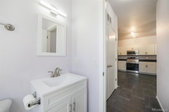 bathroom featuring vanity and toilet