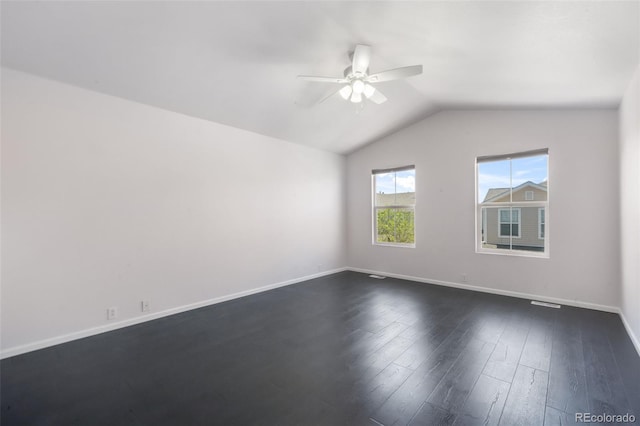 unfurnished room featuring ceiling fan, lofted ceiling, dark wood-type flooring, and baseboards