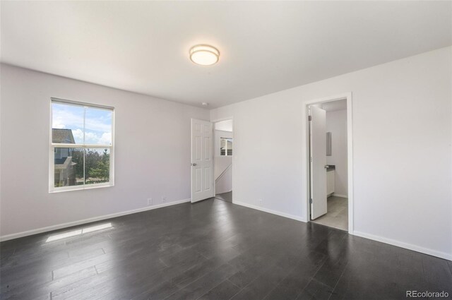 empty room with wood finished floors and baseboards