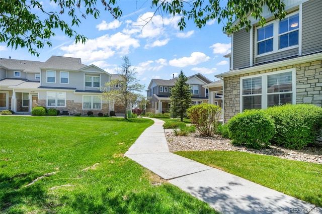 view of community featuring a residential view and a yard