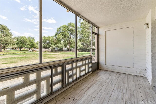 unfurnished sunroom featuring plenty of natural light