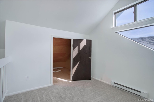 bonus room with a baseboard heating unit, lofted ceiling, and light colored carpet