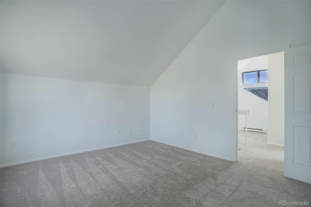 bonus room featuring light carpet, a baseboard radiator, baseboards, and vaulted ceiling