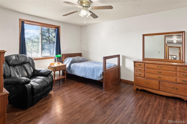 bedroom with a ceiling fan, dark wood finished floors, a textured ceiling, and baseboards