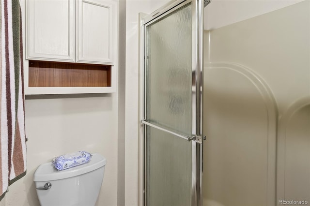 full bathroom featuring toilet and an enclosed shower