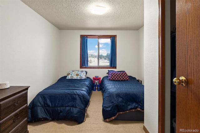 carpeted bedroom featuring a textured ceiling