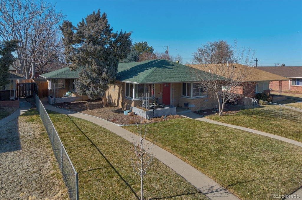 single story home with covered porch and a front lawn