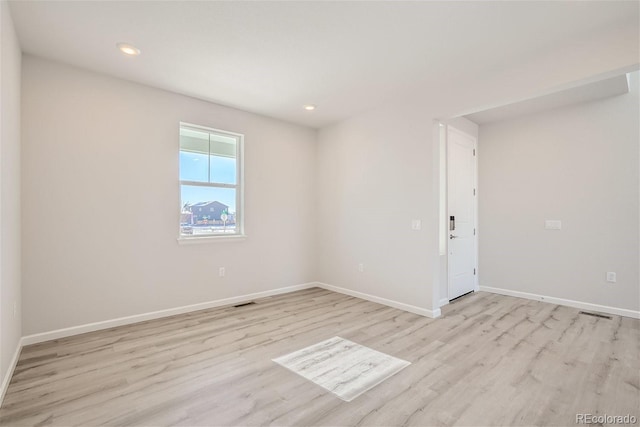 unfurnished room featuring light wood-style floors, baseboards, and recessed lighting