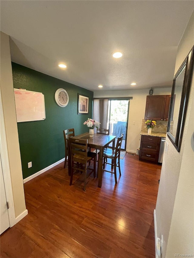 dining area with dark hardwood / wood-style floors