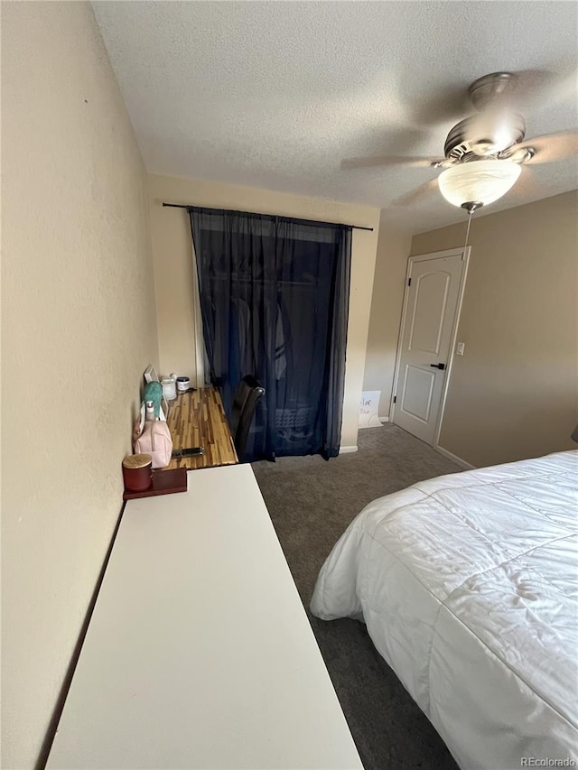 carpeted bedroom with a textured ceiling and ceiling fan