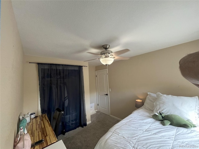 bedroom with a textured ceiling, carpet flooring, and ceiling fan