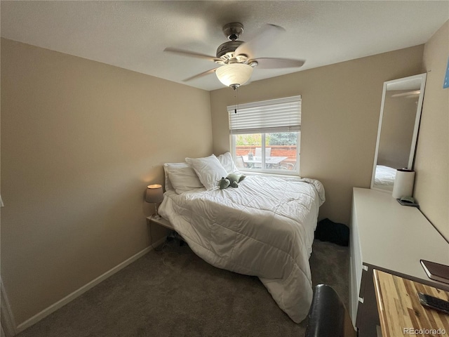 bedroom with ceiling fan and dark carpet