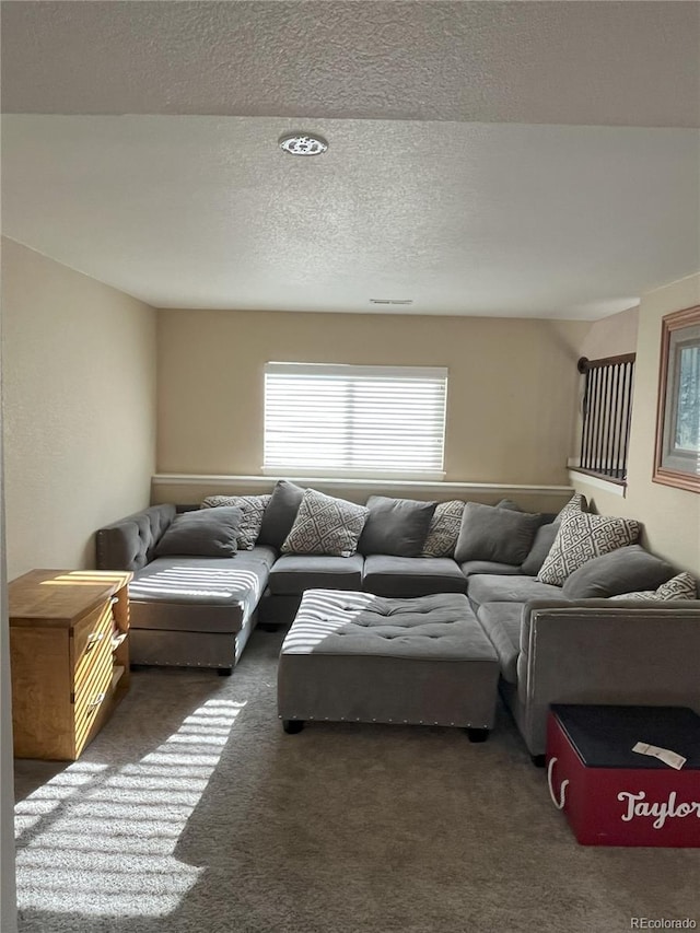 living room with a textured ceiling and dark carpet