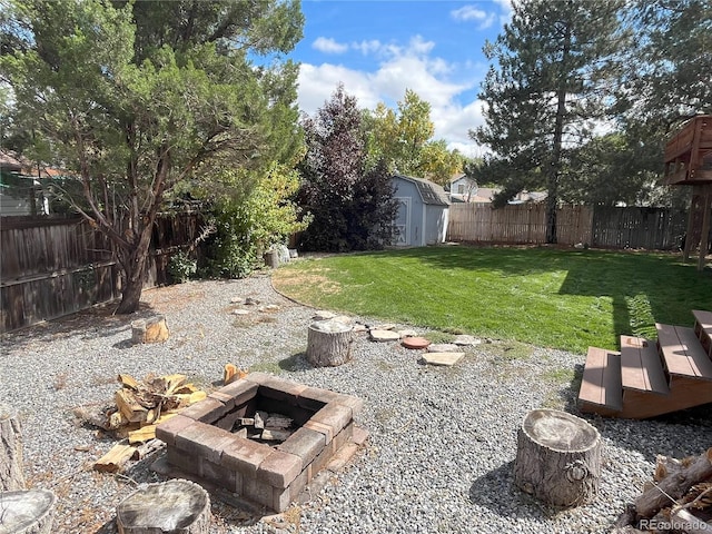 view of yard featuring a shed and a fire pit