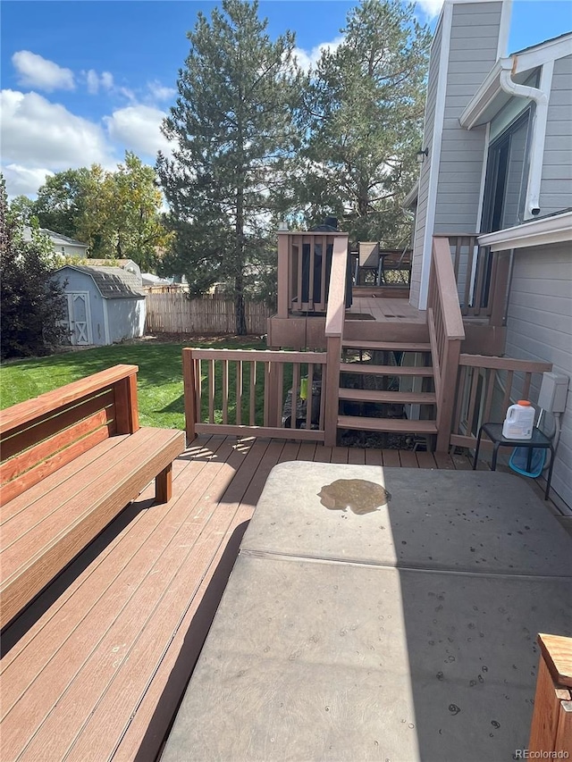 wooden deck with a lawn and a shed