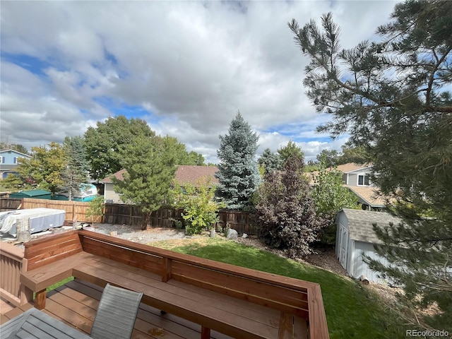 view of yard featuring a storage shed and a deck