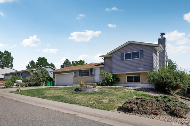 108 Olympus Cir, Lone Tree, CO 80124 - tri-level home with brick siding, a garage, a chimney, a front lawn, and concrete driveway