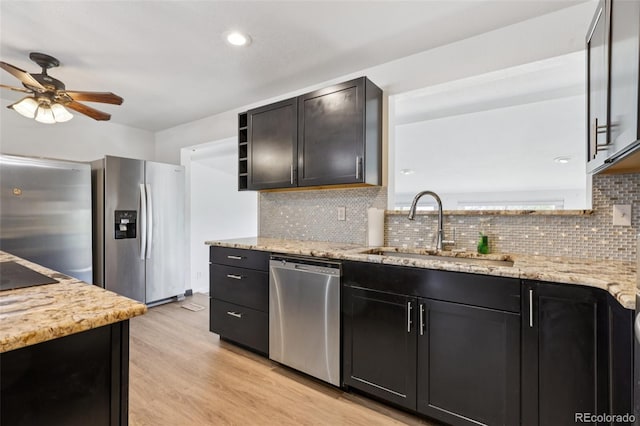 108 Olympus Cir, Lone Tree, CO 80124 - kitchen with appliances with stainless steel finishes, a ceiling fan, backsplash, light stone countertops, and recessed lighting