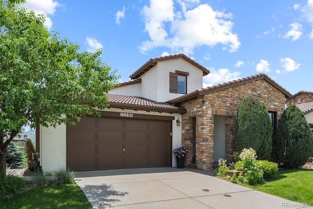 15290 W Baker Ave, Lakewood, CO 80228 - mediterranean / spanish home with concrete driveway, a tile roof, stone siding, a garage, and stucco siding
