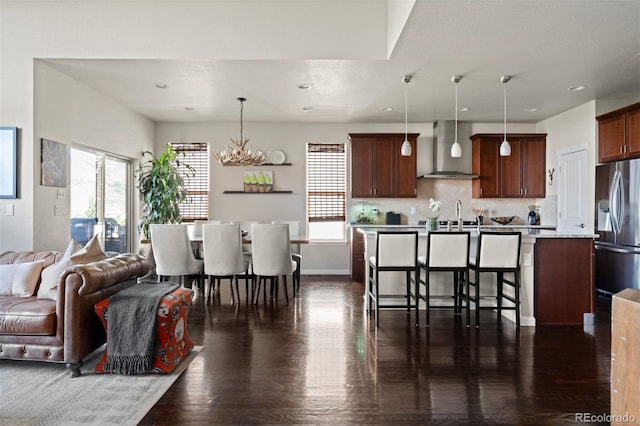 15290 W Baker Ave, Lakewood, CO 80228 - living room with dark wood-style floors, plenty of natural light, a chandelier, and recessed lighting