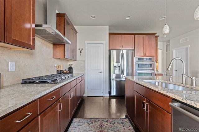 15290 W Baker Ave, Lakewood, CO 80228 - kitchen with appliances with stainless steel finishes, wall chimney range hood, dark wood-type flooring, light stone countertops, and decorative backsplash