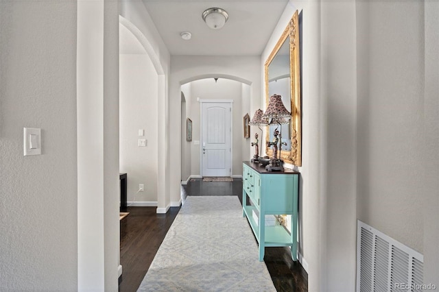 15290 W Baker Ave, Lakewood, CO 80228 - hallway with arched walkways and dark wood-type flooring