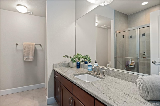 15290 W Baker Ave, Lakewood, CO 80228 - bathroom featuring vanity, a shower stall, and tile patterned flooring