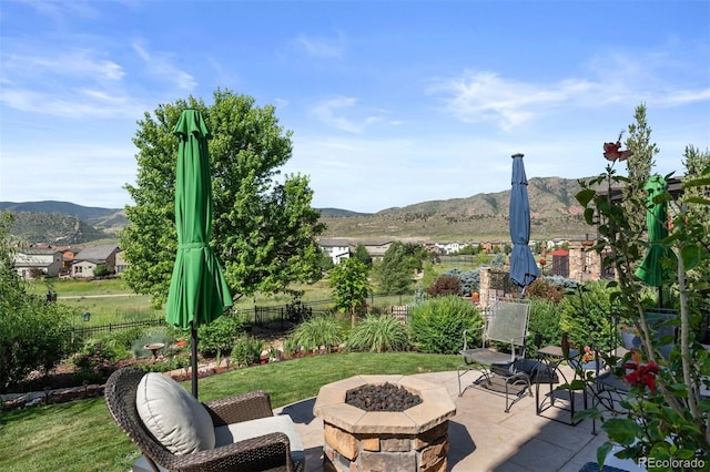 15290 W Baker Ave, Lakewood, CO 80228 - fenced backyard featuring a fire pit, a patio, and a mountain view