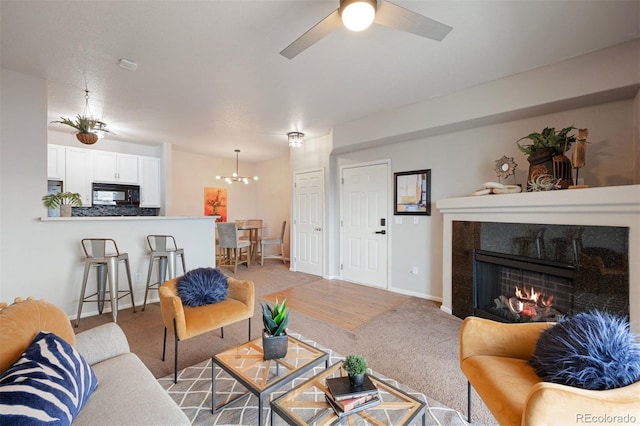 carpeted living room featuring ceiling fan