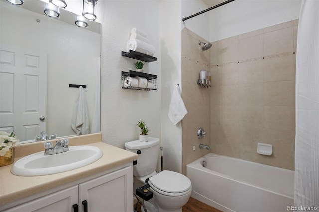 full bathroom featuring shower / bath combo, toilet, and vanity