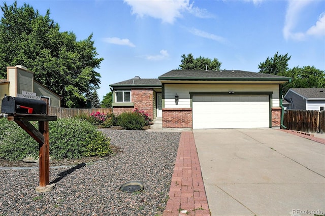 5317 S Truckee Ct, Centennial, CO 80015 - view of front facade featuring brick siding, concrete driveway, and an attached garage