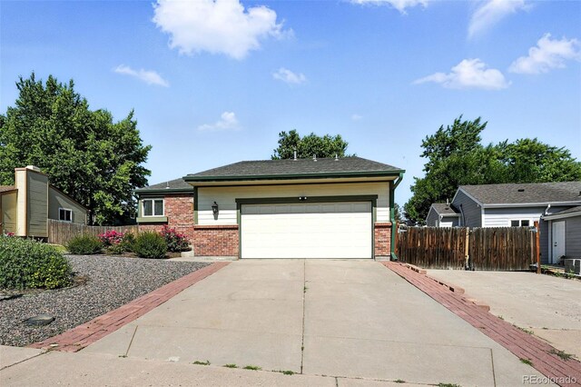 5317 S Truckee Ct, Centennial, CO 80015 - view of front facade with brick siding, concrete driveway, and a garage