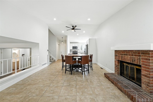 5317 S Truckee Ct, Centennial, CO 80015 - dining space with a brick fireplace, lofted ceiling, a ceiling fan, stairway, and recessed lighting