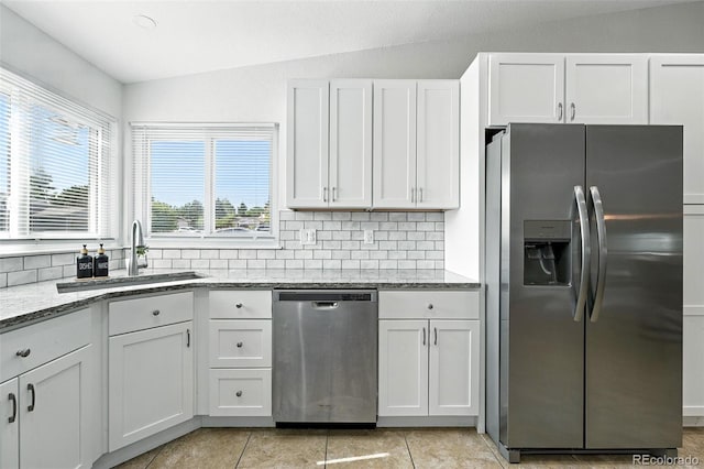 5317 S Truckee Ct, Centennial, CO 80015 - kitchen featuring appliances with stainless steel finishes, light stone countertops, decorative backsplash, white cabinets, and lofted ceiling