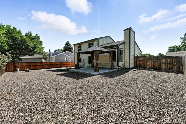 5317 S Truckee Ct, Centennial, CO 80015 - back of house with a gazebo, a patio area, a chimney, and a fenced backyard