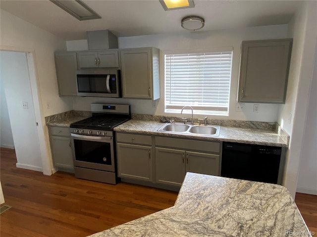 kitchen with dark hardwood / wood-style floors, gray cabinetry, sink, and stainless steel appliances