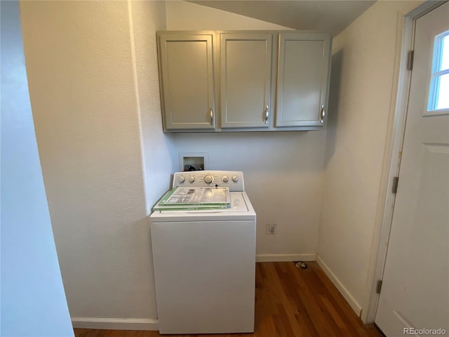 clothes washing area featuring washer / clothes dryer, dark wood-type flooring, and cabinets