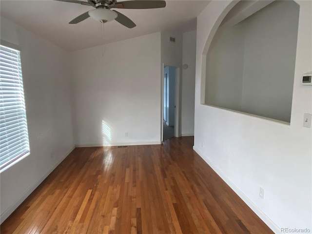 spare room featuring dark hardwood / wood-style floors and ceiling fan