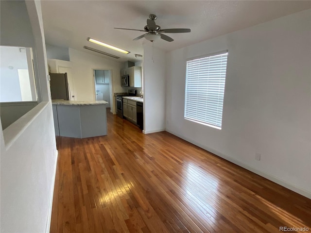 unfurnished living room featuring wood-type flooring and ceiling fan