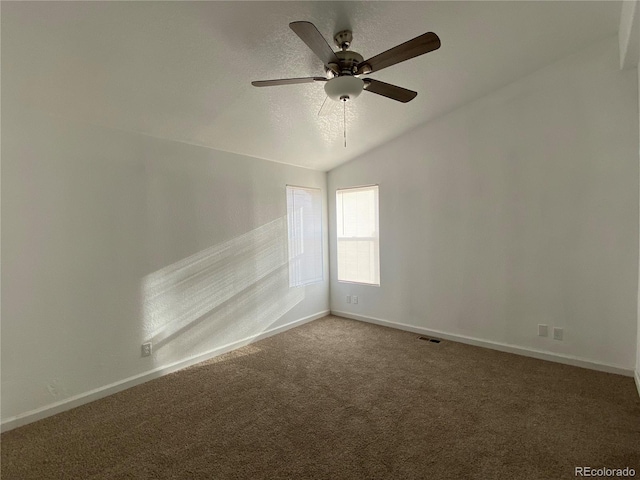 spare room featuring carpet, lofted ceiling, and ceiling fan