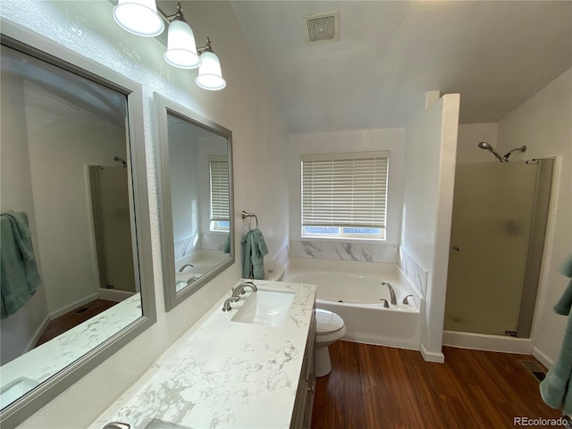 full bathroom featuring shower with separate bathtub, toilet, vanity, and hardwood / wood-style floors