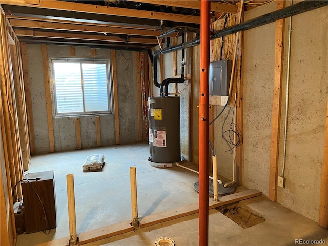 basement featuring electric panel and electric water heater