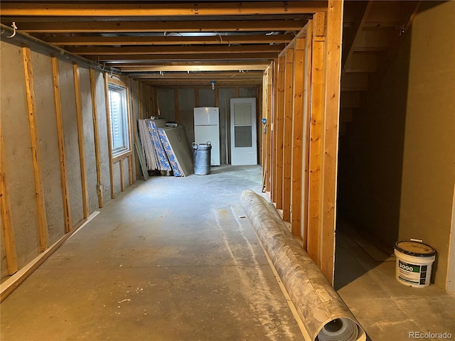 basement with white refrigerator