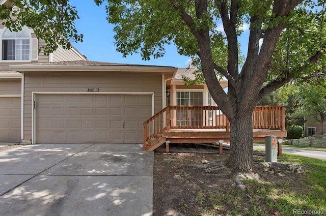 4883 W 68th Ave Unit 3, Westminster, CO 80030 - view of front of home with concrete driveway, an attached garage, and roof with shingles