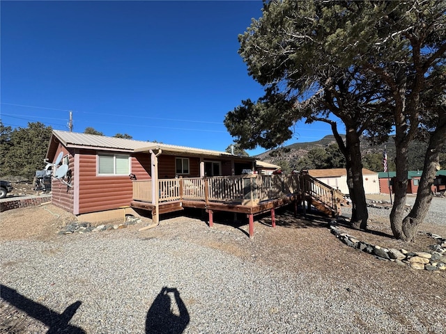 view of front of property featuring a deck with mountain view