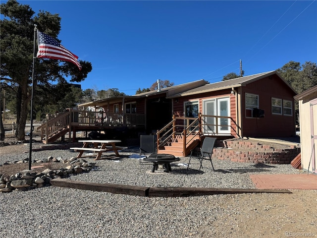 back of property with a wooden deck and cooling unit