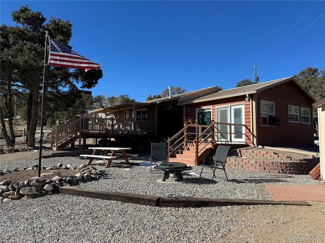 back of property with a wooden deck and french doors