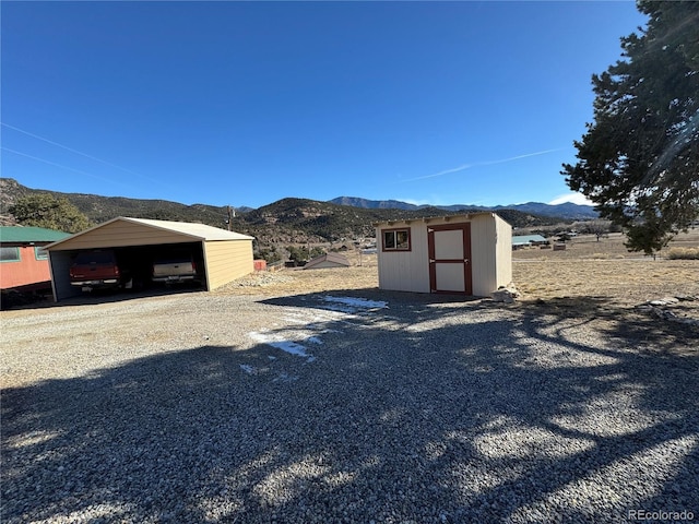 exterior space featuring a mountain view and a storage unit