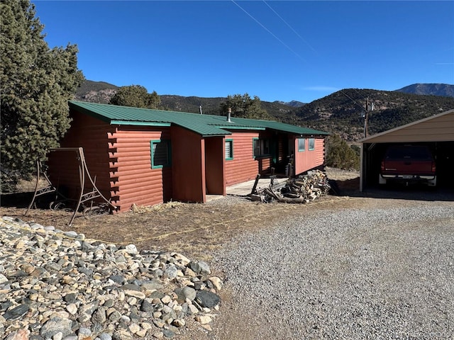 exterior space featuring a carport and a mountain view